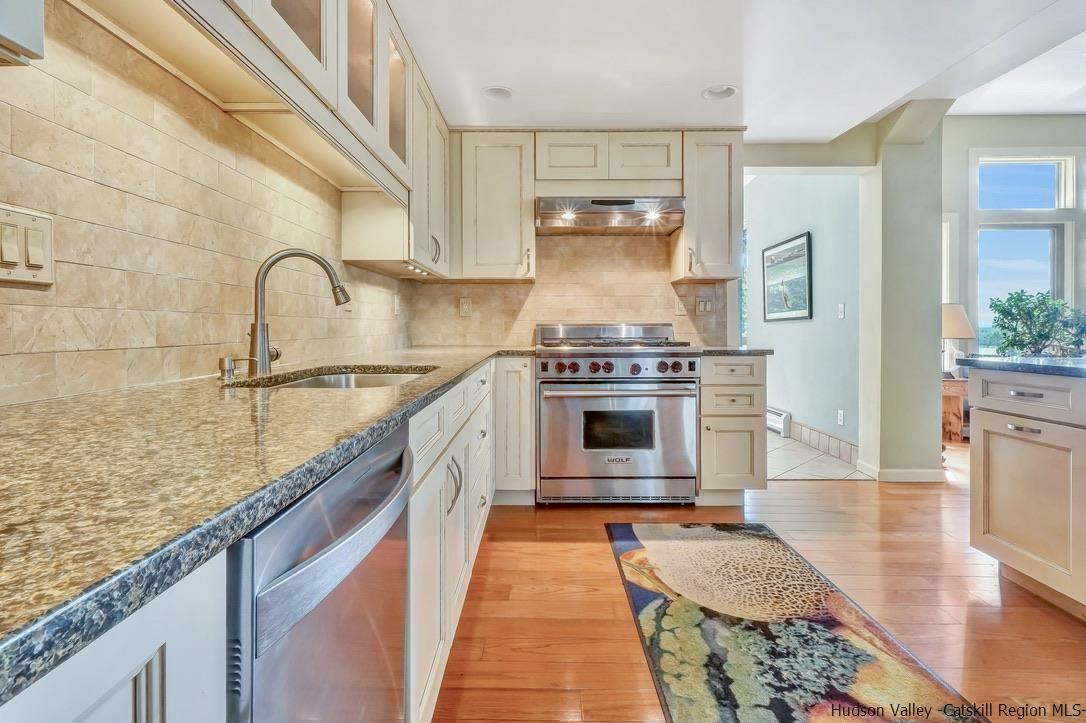 71 Carly Road Woodstock, NY 12498 - Photo 8 of 34 a kitchen with kitchen island granite countertop a stove a sink and a wooden floors