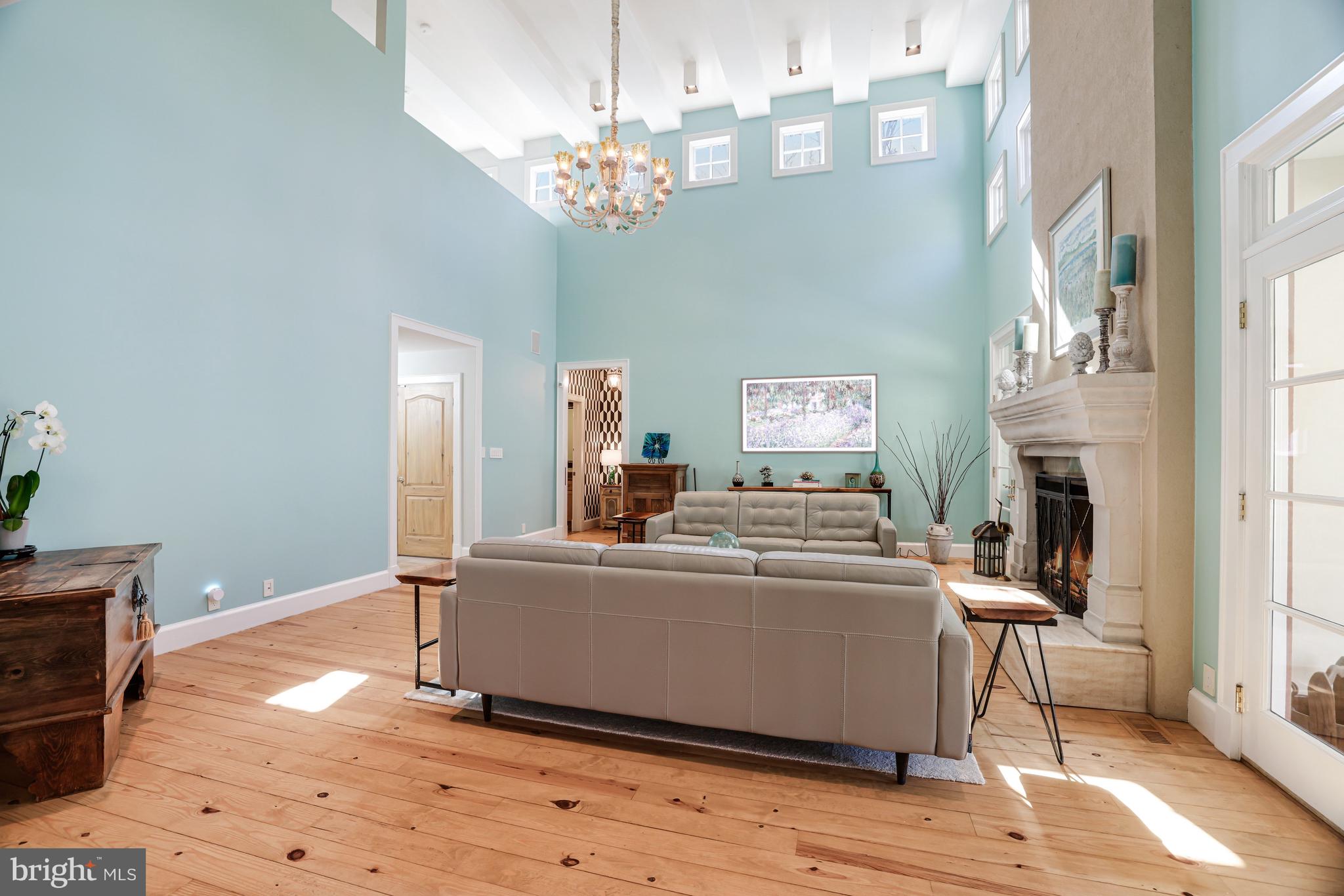 1127 Bellview Road McLean, VA 22102 - Photo 14 of 67 a living room with a dining table wooden floor and a chandelier