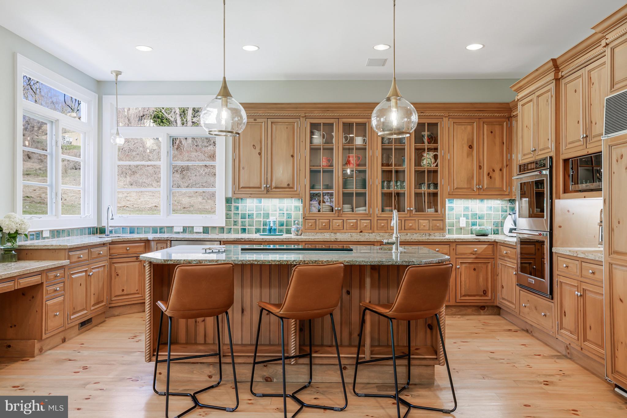 1127 Bellview Road McLean, VA 22102 - Photo 17 of 67 a kitchen with granite countertop a counter space dining table and stainless steel appliances