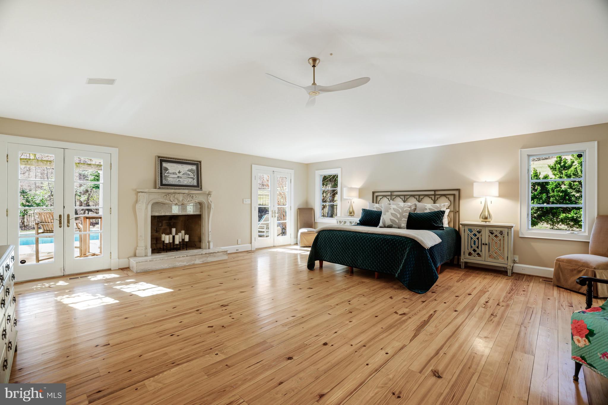 1127 Bellview Road McLean, VA 22102 - Photo 26 of 67 a spacious bedroom with a bed and a fireplace