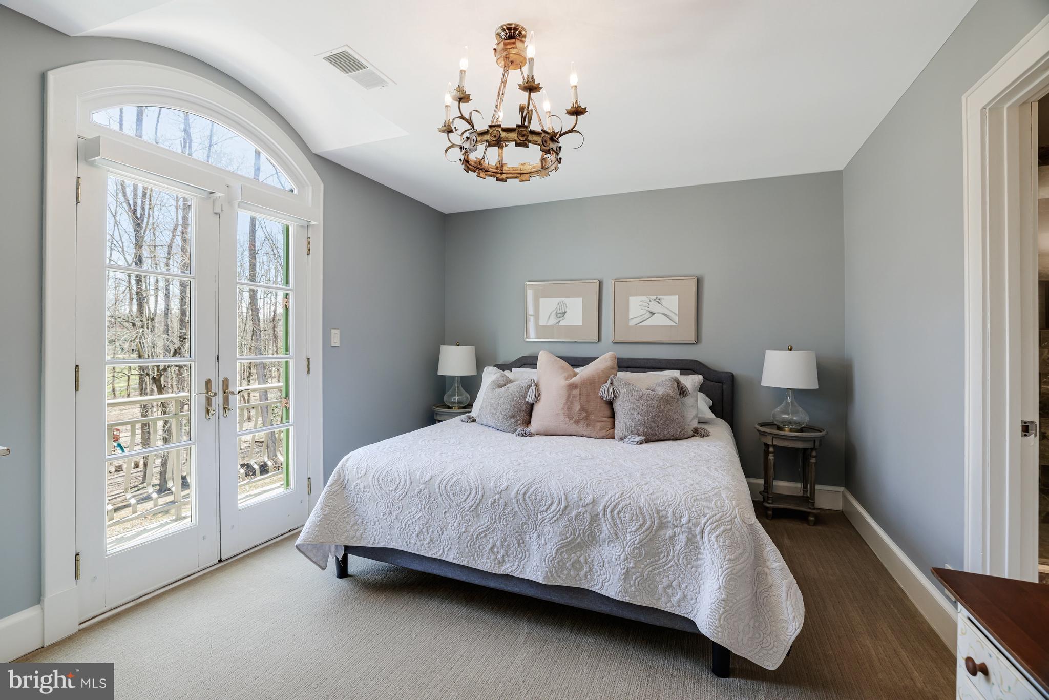 1127 Bellview Road McLean, VA 22102 - Photo 42 of 67 a bedroom with a large bed and a chandelier