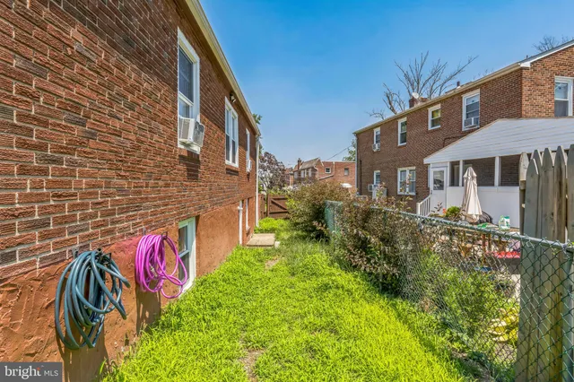 a pathway of a house with a yard