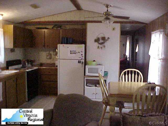 50 Raines Road Farmville, VA 23901 - Photo 3 of 10 a kitchen with a refrigerator a stove a sink and a dining table