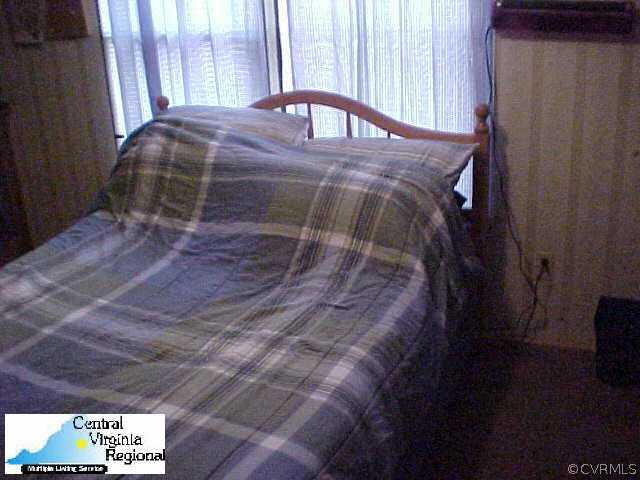 50 Raines Road Farmville, VA 23901 - Photo 9 of 10 a bed sitting in a bedroom next to a window