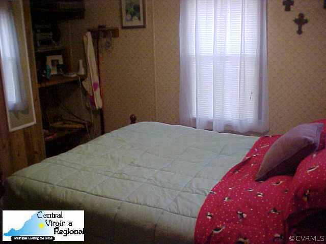 50 Raines Road Farmville, VA 23901 - Photo 10 of 10 a bedroom with a bed and a refrigerator