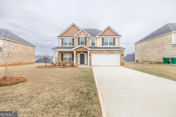 a front view of a house with a yard
