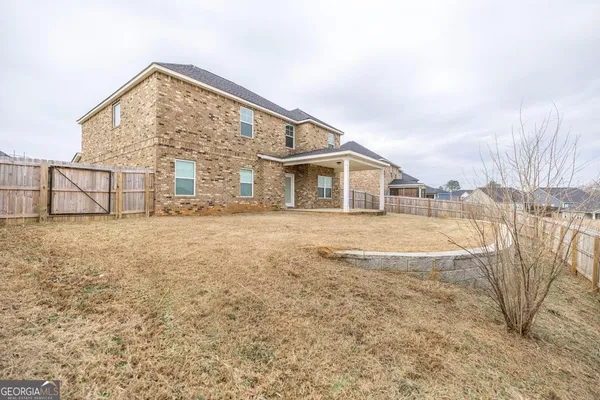 a view of house with yard and mountain view in front of it