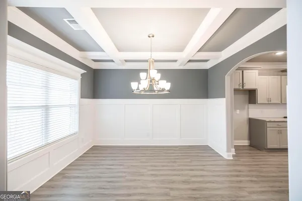 a view of a kitchen with a dishwasher cabinets and wooden floor