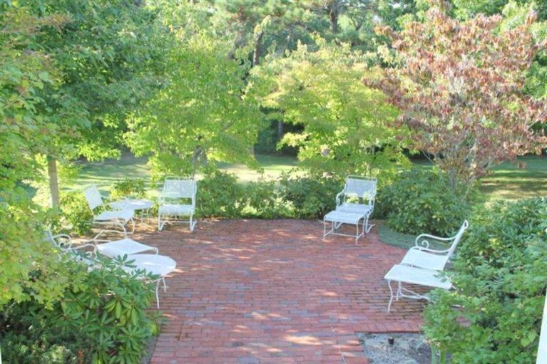 56 Farm Valley Road Osterville, MA 02655 - Photo 18 of 23 a view of a backyard with lawn chairs and a large tree