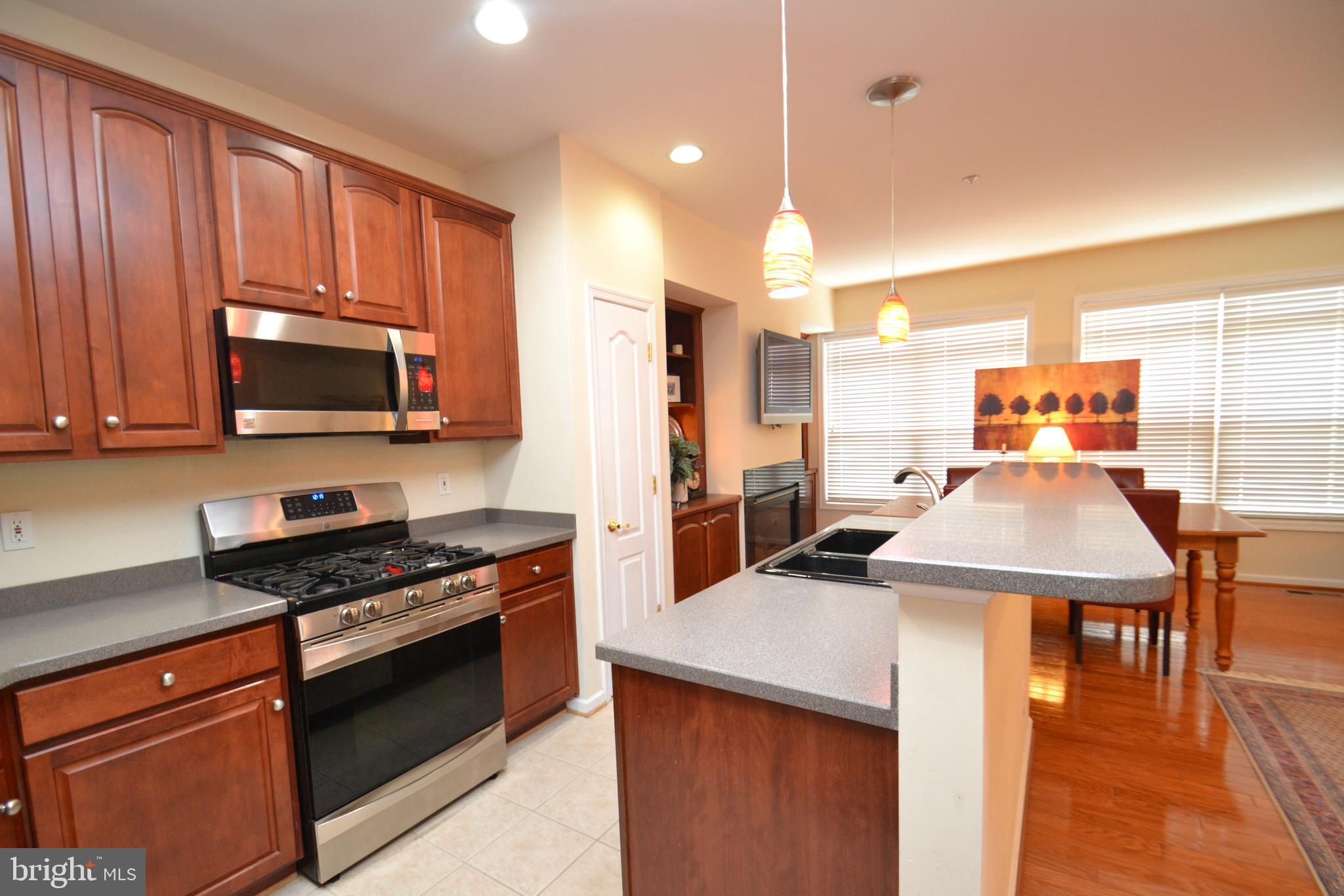 10207 Rutland Round Road, Unit 65 Columbia, MD 21044 - Photo 16 of 32 Kitchen w/breakfast bar & cherry stained wood cabs