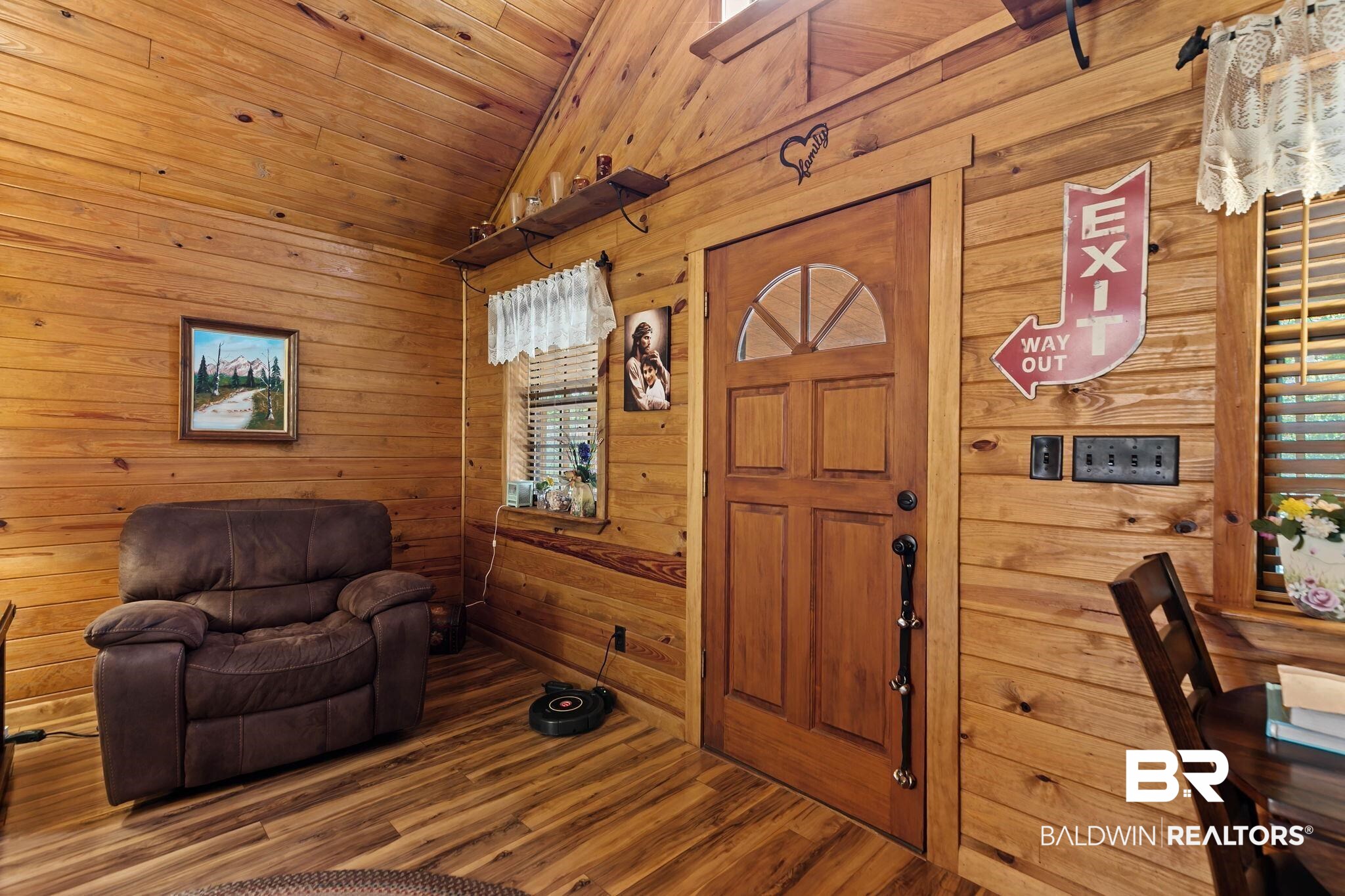 724 Rowell Lane Brewton, AL 36426 - Photo 10 of 40 Living area with wooden walls, wood finished floors, wooden ceiling, and high vaulted ceiling