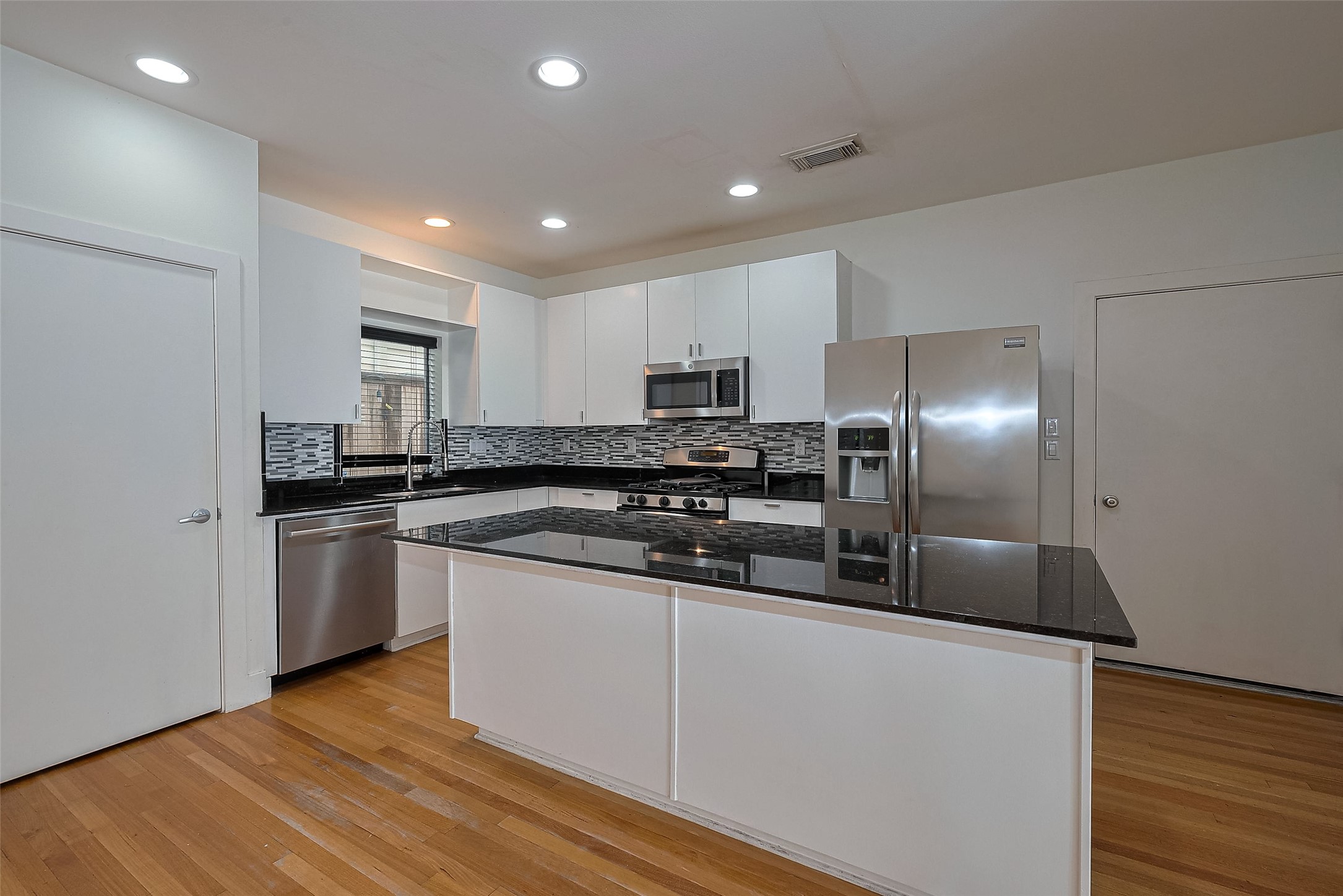 4331 Eigel Street Houston, TX 77007 - Photo 16 of 38 a kitchen with stainless steel appliances granite countertop a refrigerator and a stove top oven