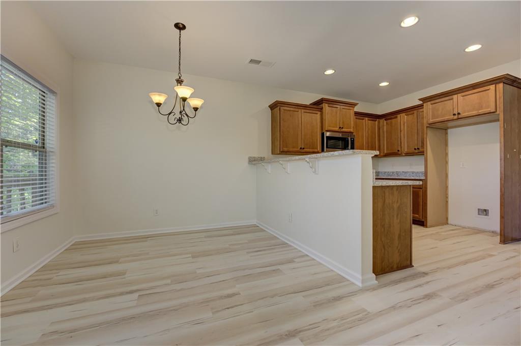 605 Summit Point Canton, GA 30114 - Photo 16 of 56 a view of a kitchen with a sink and dishwasher a refrigerator with wooden floor
