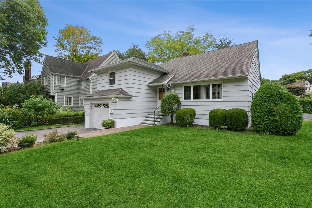 21 Chatham Road New Rochelle, NY 10804 - Photo 1 of 1 a front view of a house with a yard and garage
