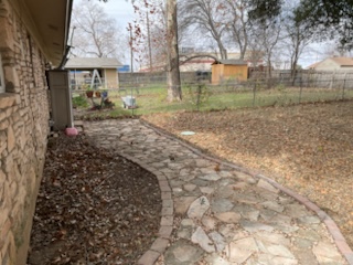 7402 Southgate Lane, Unit B Austin, TX 78744 - Photo 13 of 16 a backyard of a house with lots of green space