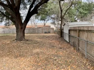 a view of yard with large trees