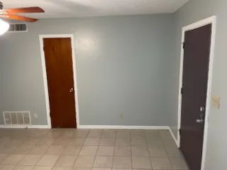 an empty room with closet and a bathroom