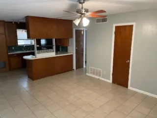 a living room with stainless steel appliances kitchen island granite countertop furniture and a fireplace