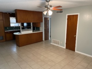 7402 Southgate Lane, Unit B Austin, TX 78744 - Photo 4 of 16 a living room with stainless steel appliances kitchen island granite countertop furniture and a fireplace