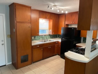 7402 Southgate Lane, Unit B Austin, TX 78744 - Photo 5 of 16 a kitchen with a refrigerator and a stove