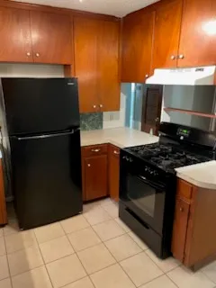 a kitchen with granite countertop a stove and a refrigerator