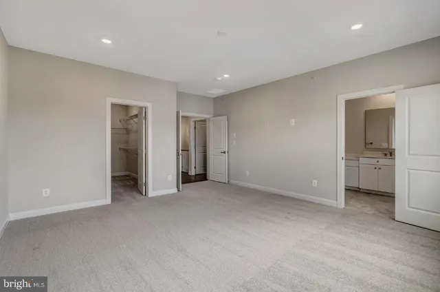 an empty room with a bathroom and a sink