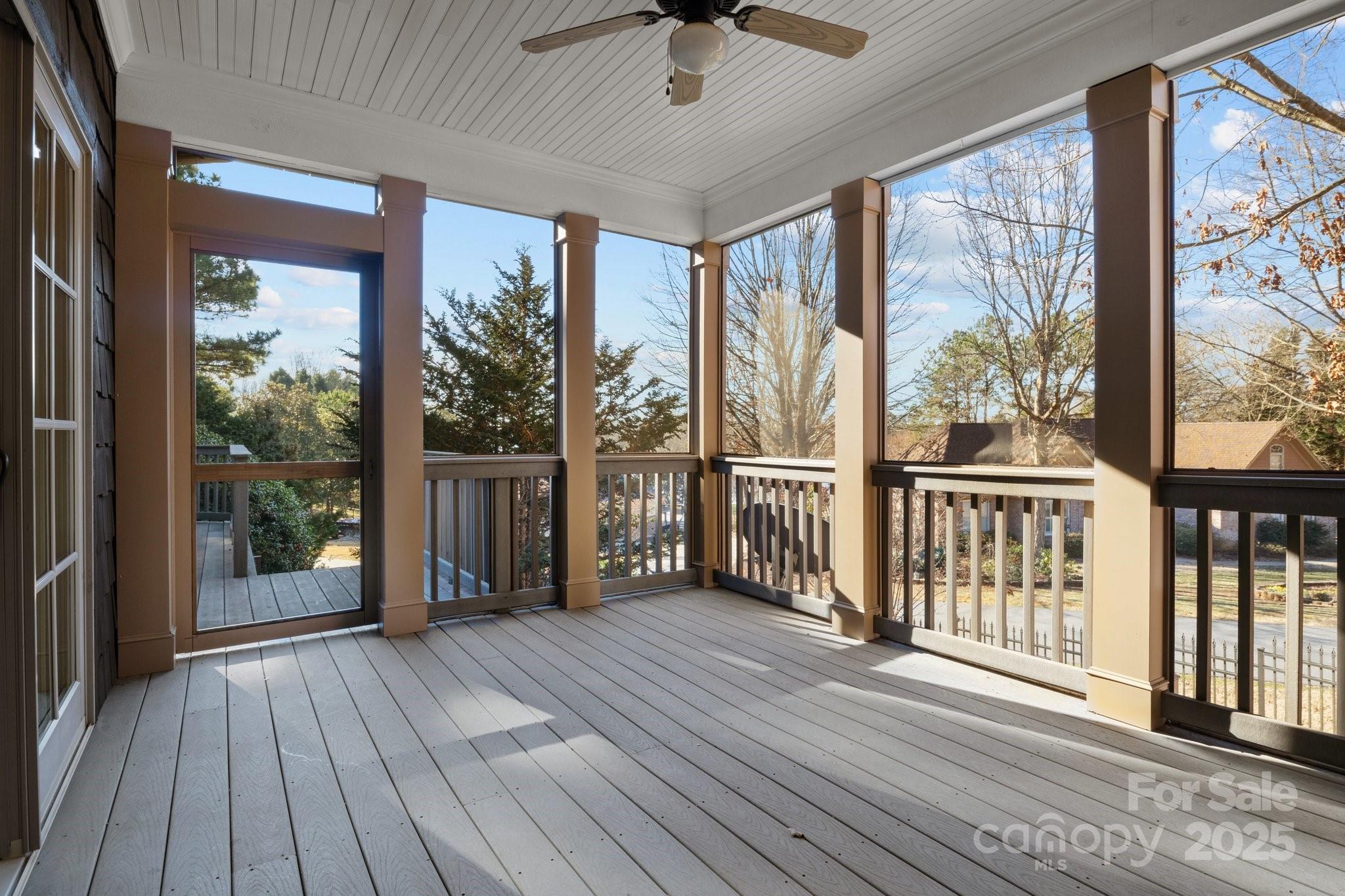 8034 Bay Pointe Drive Denver, NC 28037 - Photo 11 of 45 a view of a porch with wooden floor and floor to ceiling window