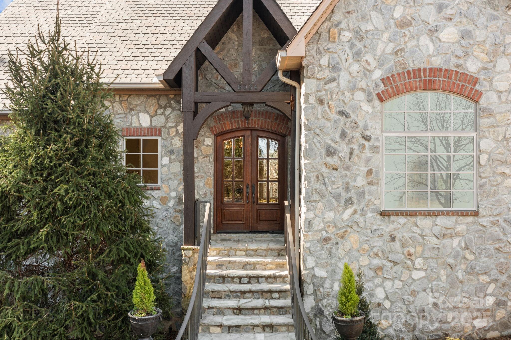 8034 Bay Pointe Drive Denver, NC 28037 - Photo 3 of 45 a front view of a house with a garden