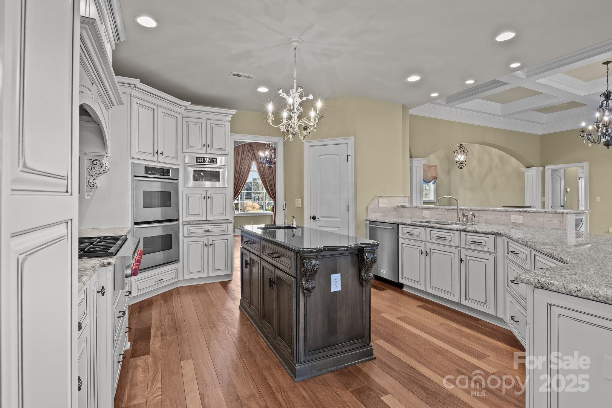 8034 Bay Pointe Drive Denver, NC 28037 - Photo 7 of 45 a kitchen with stainless steel appliances granite countertop a refrigerator a stove and a wooden floors