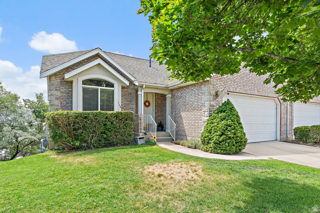148 South Ridgeview Drive Orem, UT 84058 - Photo 1 of 23 Brick-clad exterior with an arched window, white trim, and a gabled roofline
