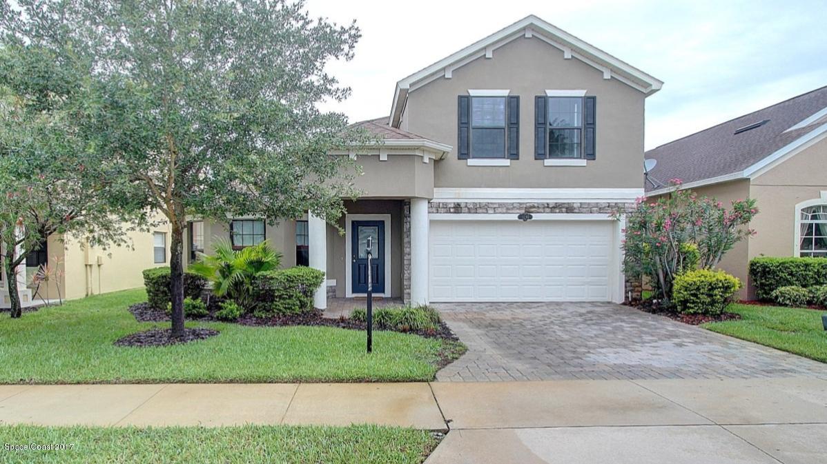 1202 Becket Place Melbourne, FL 32940 - Photo 1 of 38 a front view of a house with a yard and garage