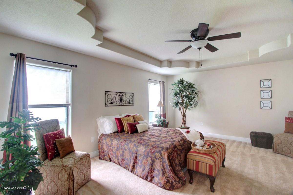 1202 Becket Place Melbourne, FL 32940 - Photo 14 of 38 a bedroom with a large bed and a window