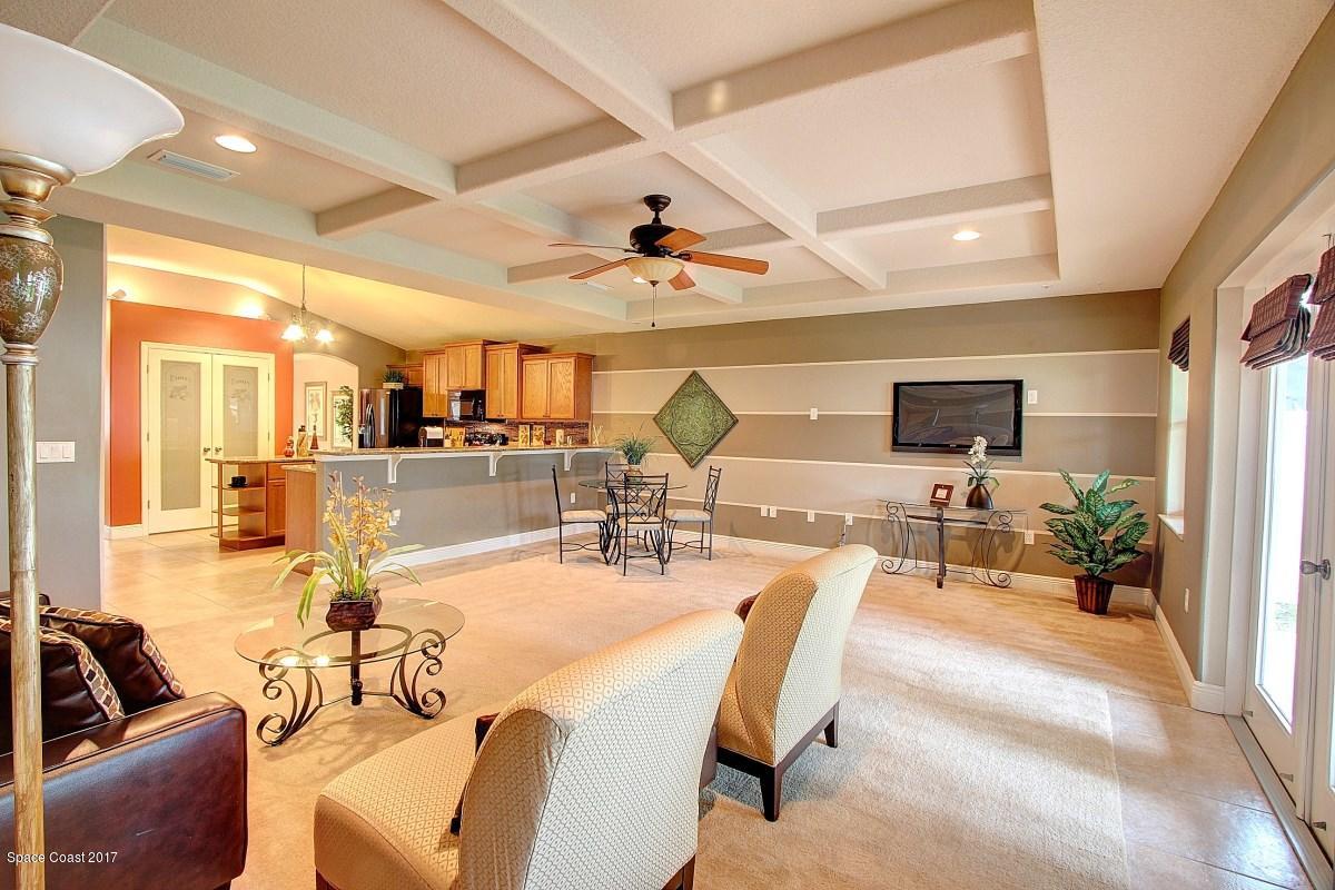 1202 Becket Place Melbourne, FL 32940 - Photo 15 of 38 a living room with lots of furniture and view of kitchen