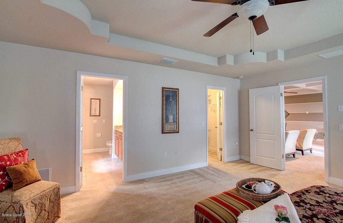 1202 Becket Place Melbourne, FL 32940 - Photo 16 of 38 a bedroom with furniture and wooden floor
