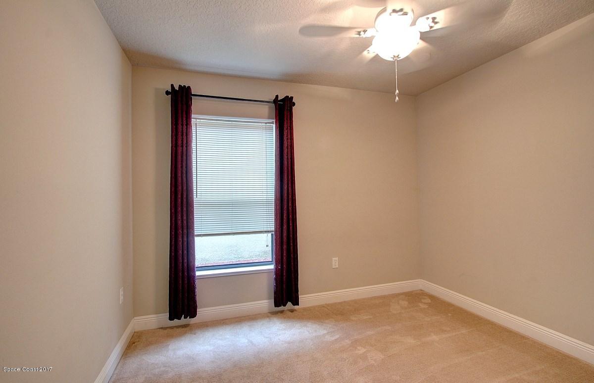 1202 Becket Place Melbourne, FL 32940 - Photo 19 of 38 an empty room with windows and fan