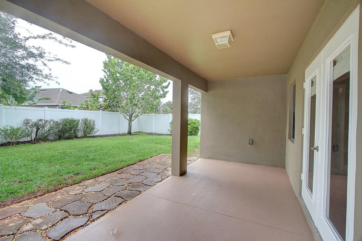 1202 Becket Place Melbourne, FL 32940 - Photo 28 of 38 a view of a porch with a big yard and large tree
