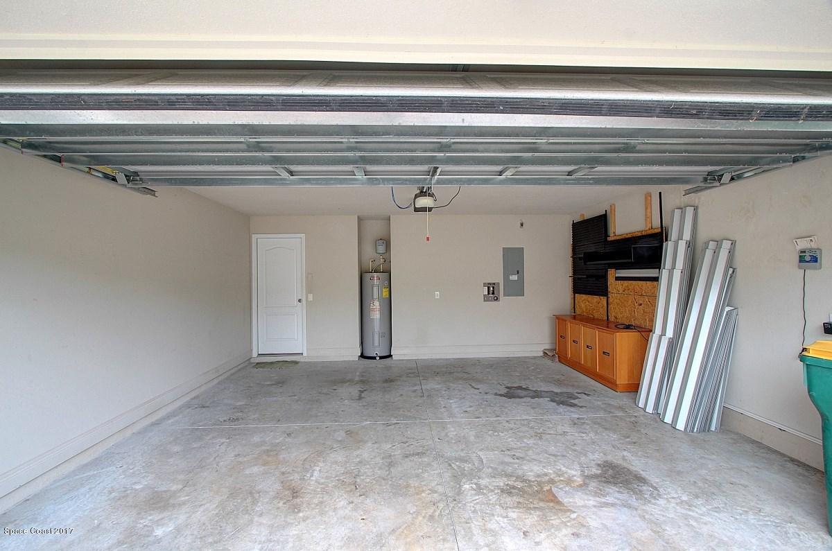 1202 Becket Place Melbourne, FL 32940 - Photo 31 of 38 a view of a hallway with wooden stairs