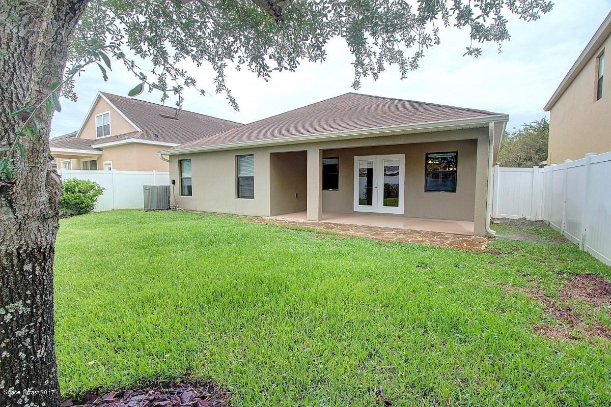 1202 Becket Place Melbourne, FL 32940 - Photo 32 of 38 a front view of a house with a yard and garage