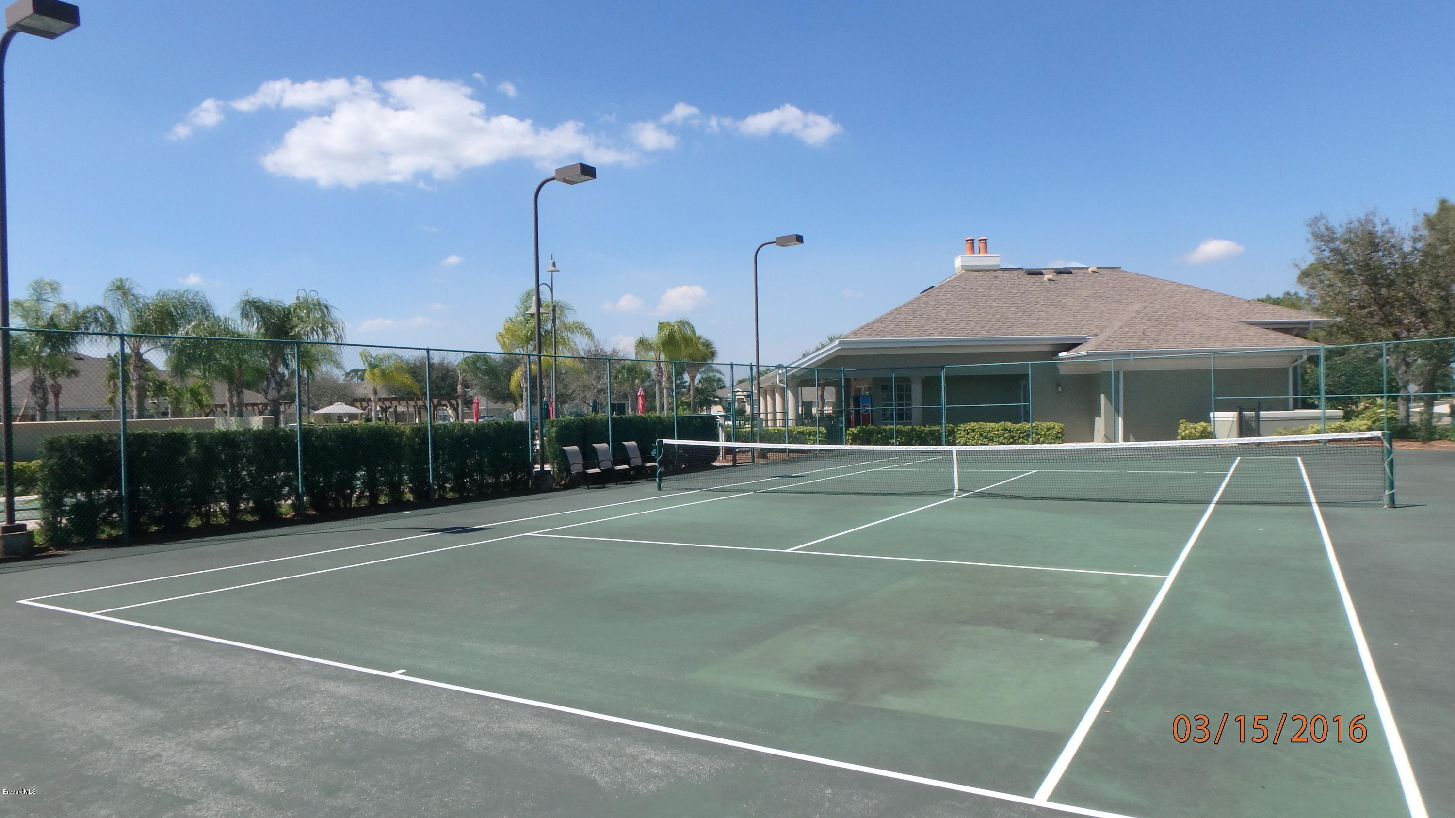1202 Becket Place Melbourne, FL 32940 - Photo 33 of 38 a view of a tennis ground with large trees