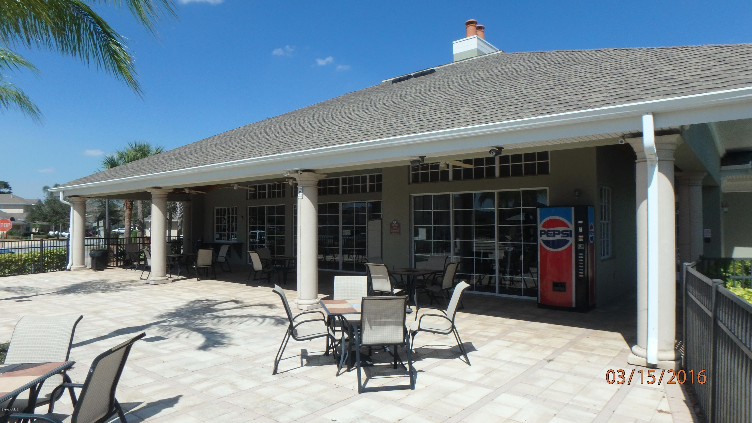 1202 Becket Place Melbourne, FL 32940 - Photo 35 of 38 a view of a patio with table and chairs and potted plants