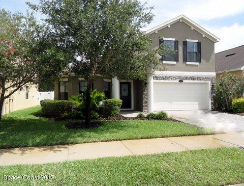 1202 Becket Place Melbourne, FL 32940 - Photo 37 of 38 a front view of a house with a yard and garage