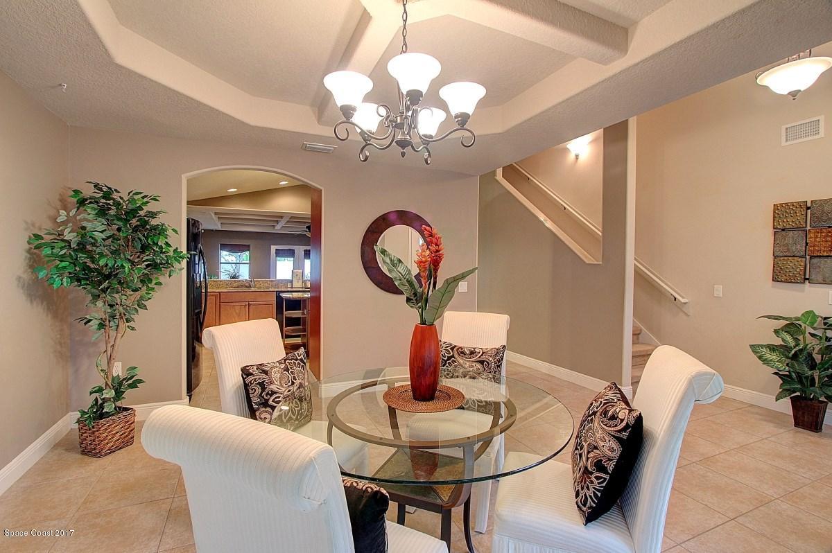 1202 Becket Place Melbourne, FL 32940 - Photo 6 of 38 a dining room with furniture and chandelier