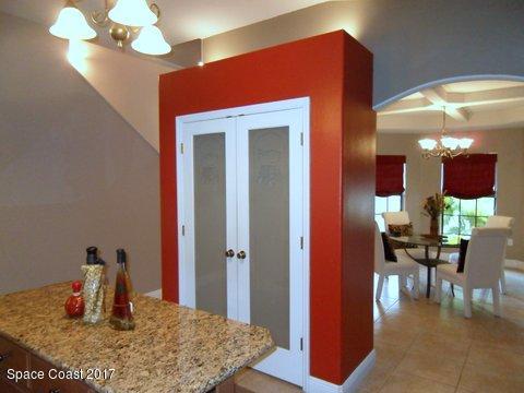 1202 Becket Place Melbourne, FL 32940 - Photo 8 of 38 a kitchen with a table and chairs in it