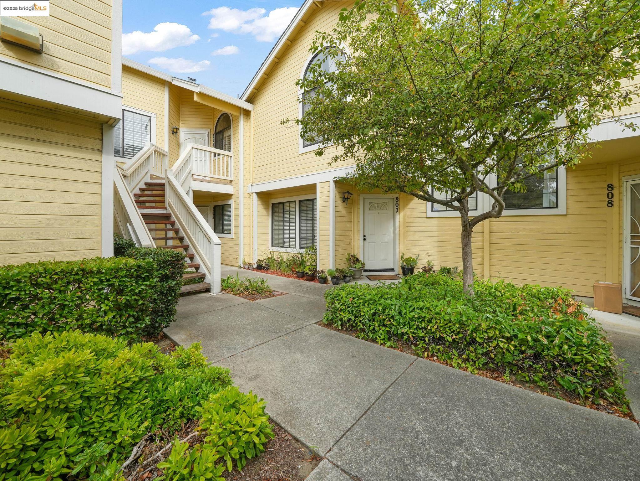 a front view of a house with a garden