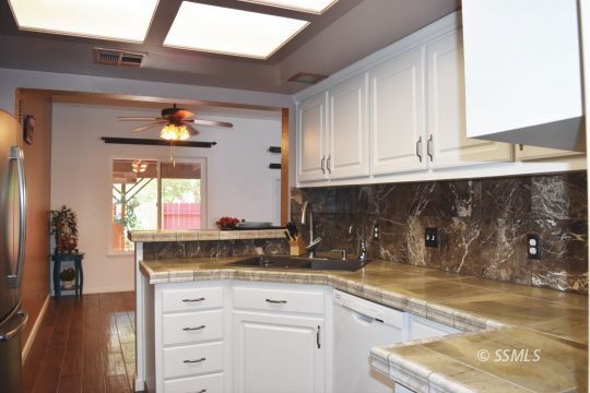 417 Montefino Drive Ridgecrest, CA 93555 - Photo 11 of 25 a kitchen with granite countertop a sink and cabinets