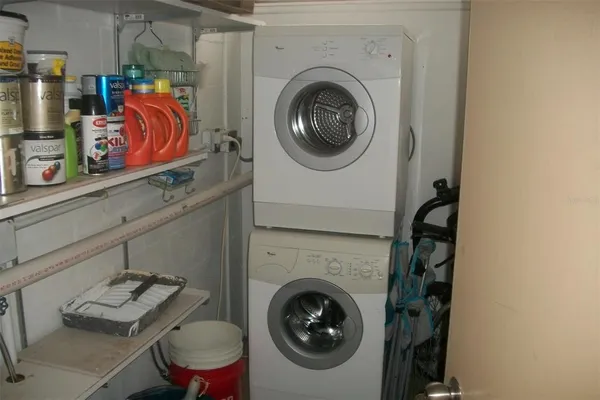 a utility room with closet dryer and washer