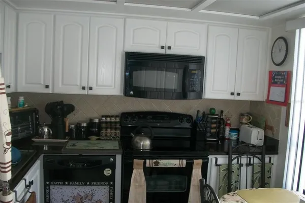 a kitchen with a table and chairs