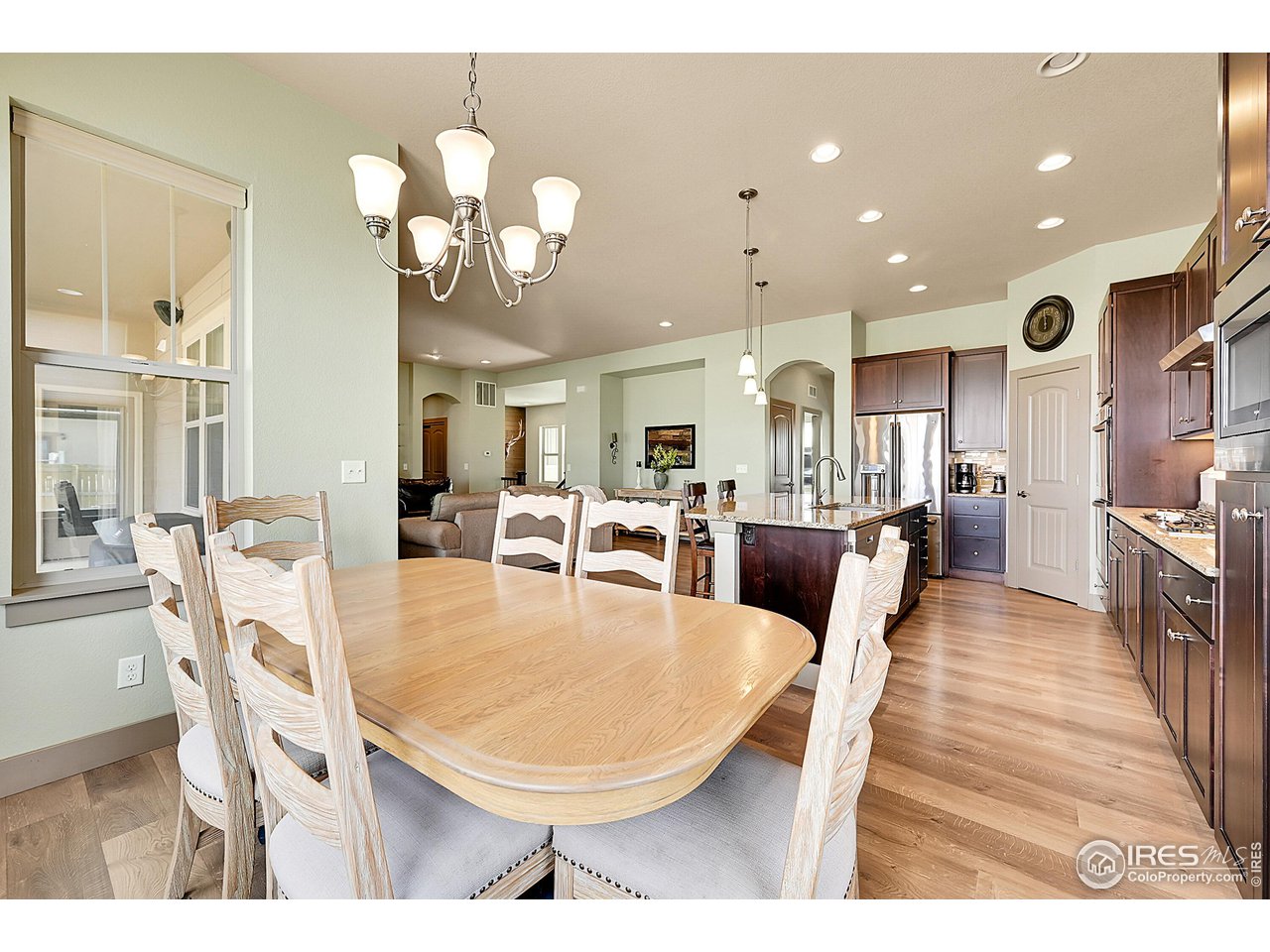 40775 Jade Drive Ault, CO 80610 - Photo 12 of 40 a living room with dining table and wooden floor