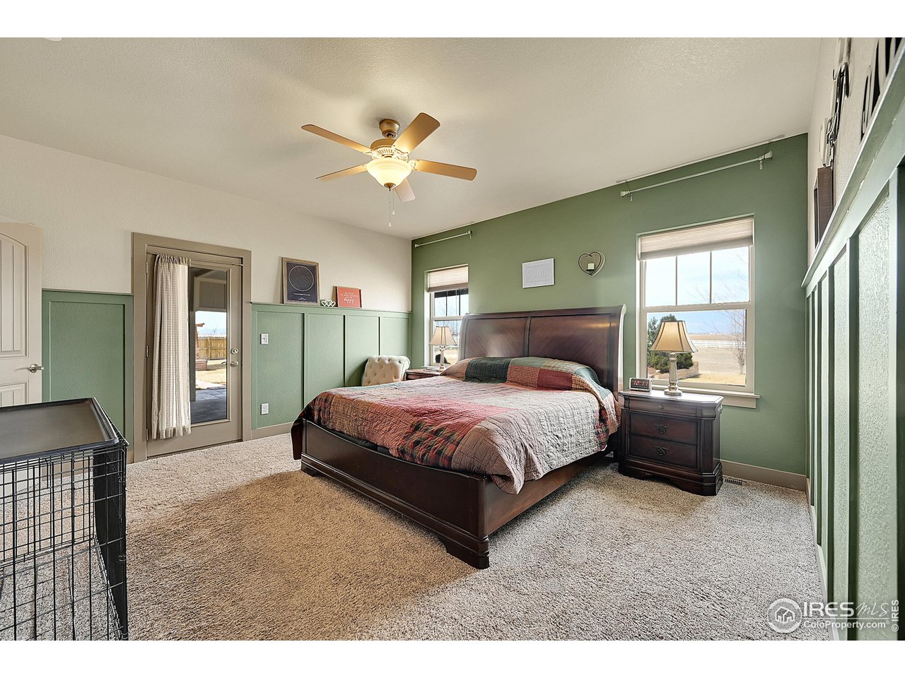 40775 Jade Drive Ault, CO 80610 - Photo 17 of 40 a spacious bedroom with a large bed and a chandelier