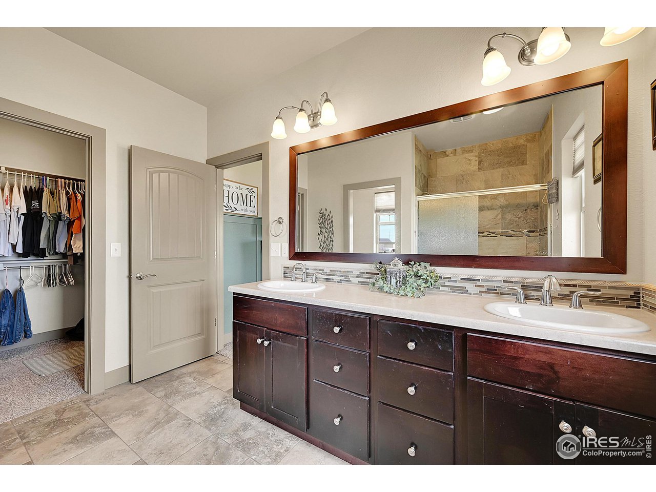 40775 Jade Drive Ault, CO 80610 - Photo 20 of 40 a bathroom with a sink double vanity and a mirror